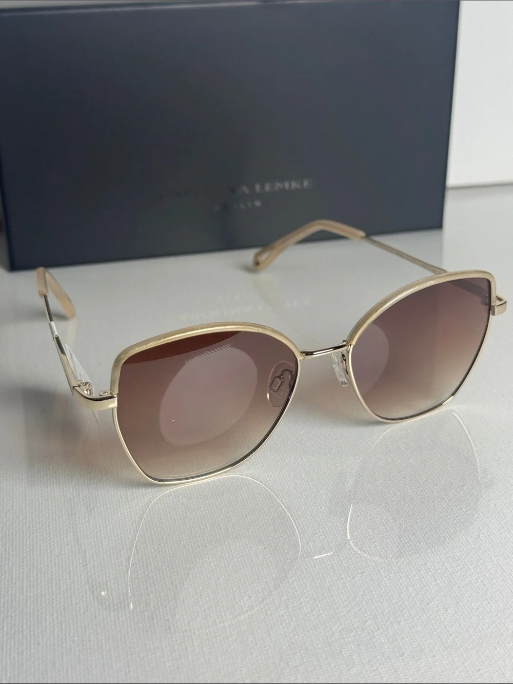 Carolina Herrera Gold Frame Sunglasses with Brown Gradient Lenses